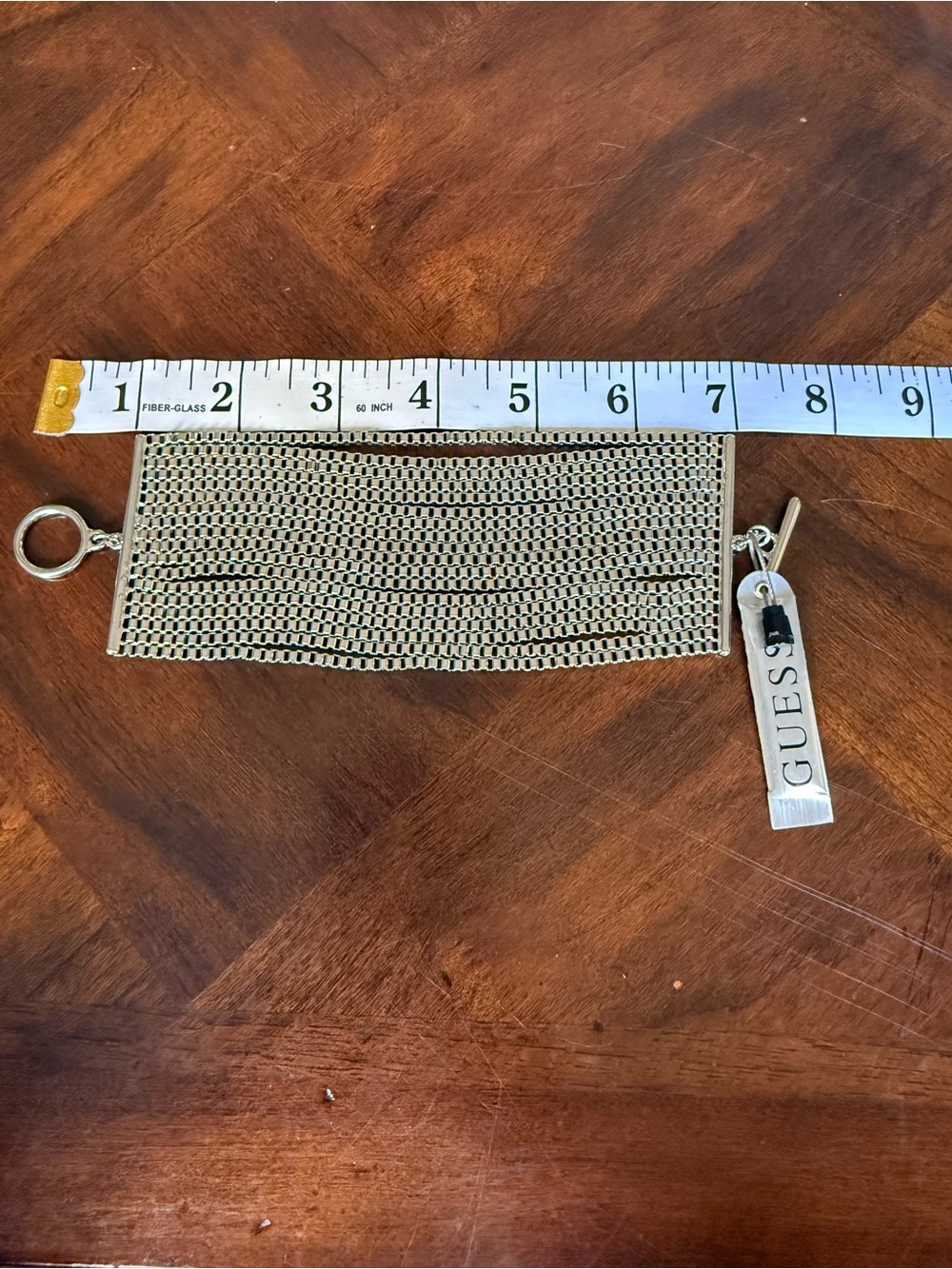 Guess Gold Tone Mesh Bracelet with Logo Tag